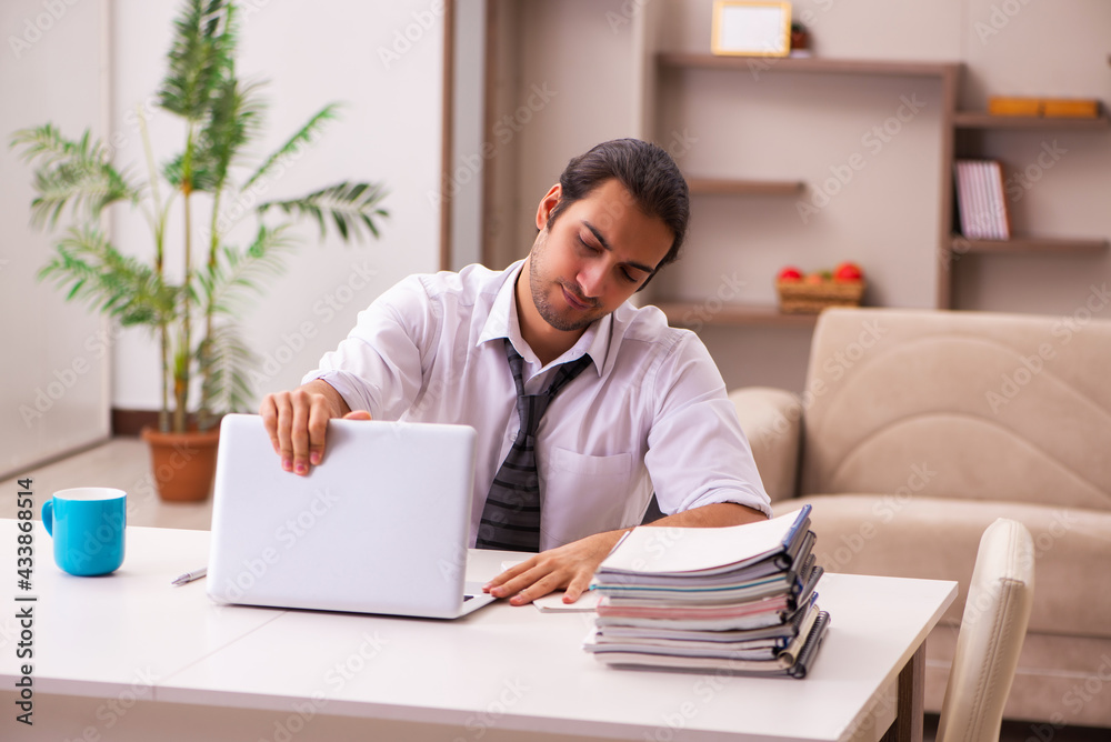 Young male employee working from home during pandemic Young male employee working from home during pandemic