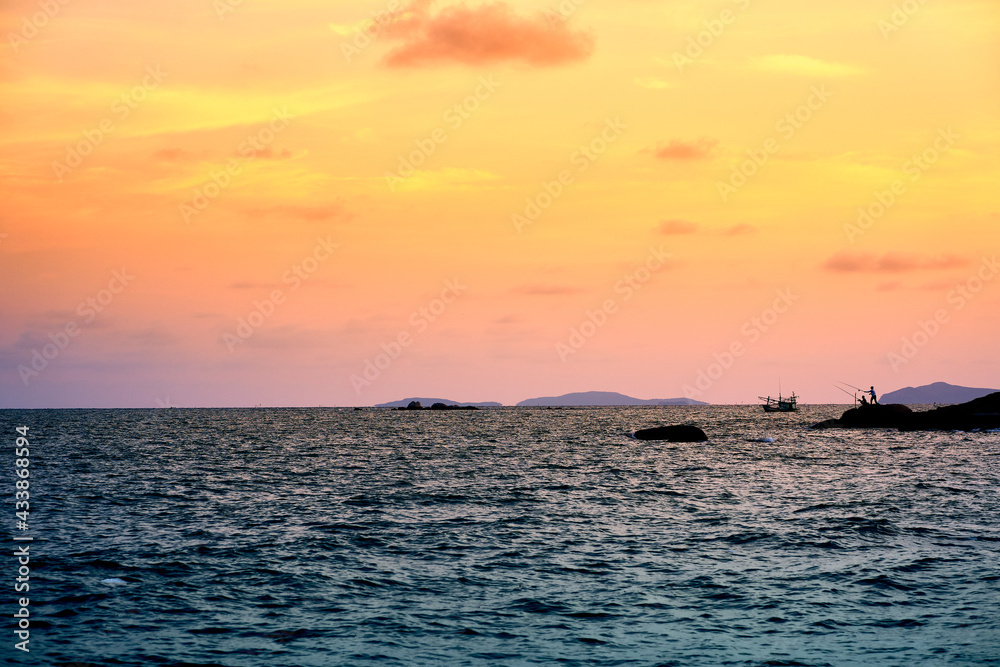 A picture of a fishing man in the evening At Phayun Beach, Ban Chang, Rayong, Thailand