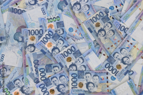 A pile of one thousand Philippines peso banknotes. Cash of Thousand dollar bills  Peso background image.