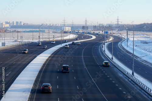 Multi-lane highway with cars in winter day.