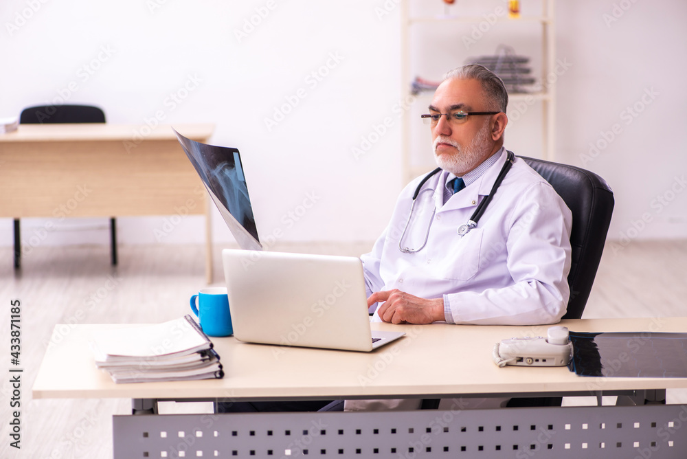 Aged male doctor radiologist working in the clinic