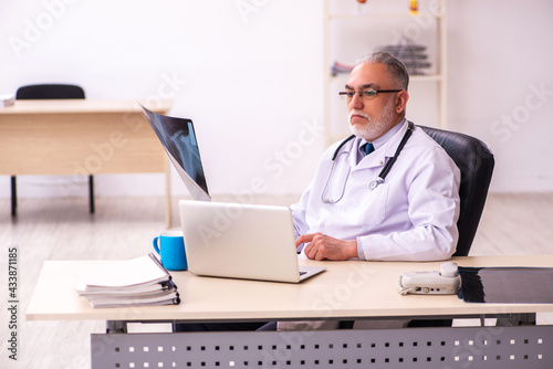 Aged male doctor radiologist working in the clinic