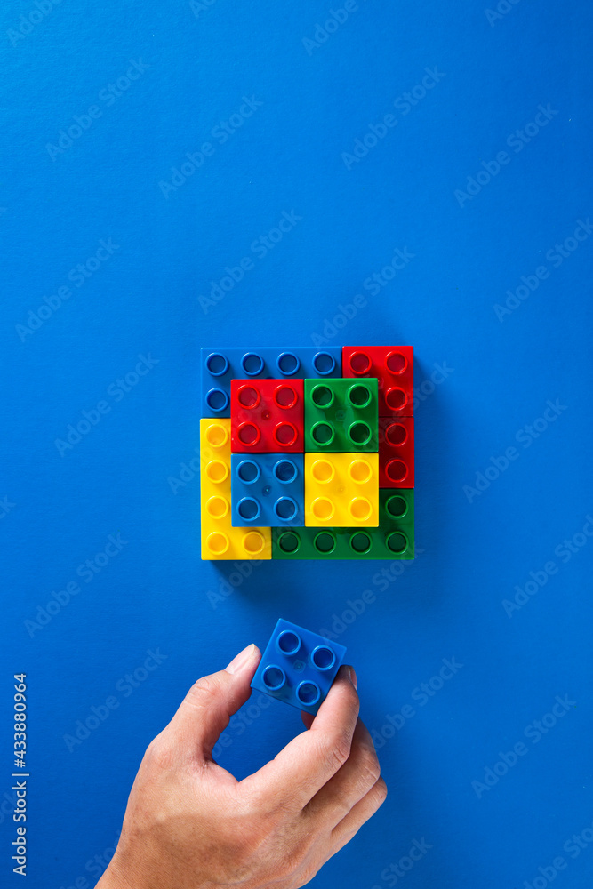 hand stacking up the plastic block hand stacking up the plastic block