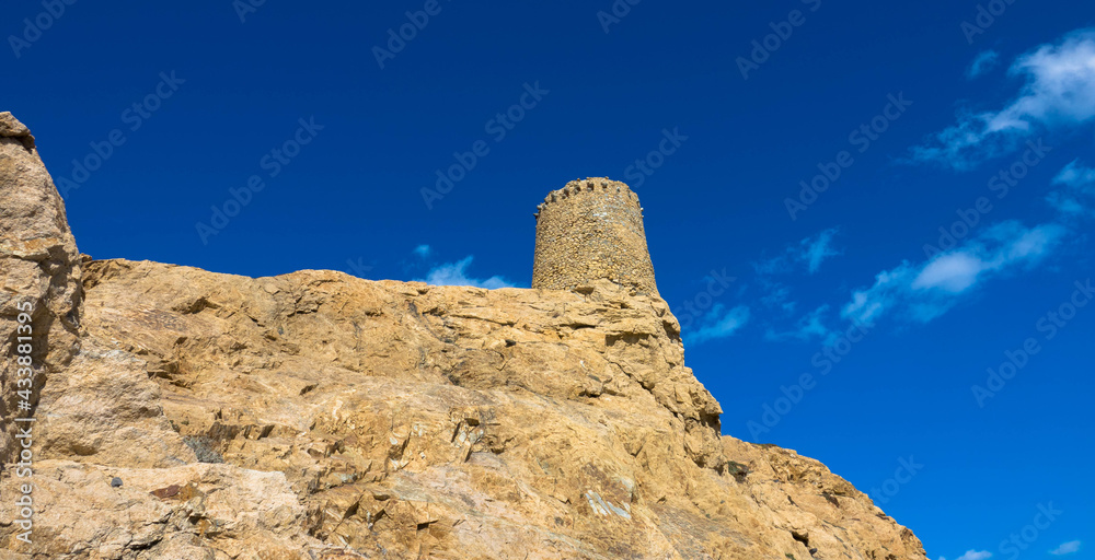 Genoese Tower on the top of the stone island Pietra, rocky promontory of Ile Rousse, a famous city from Corsica, France