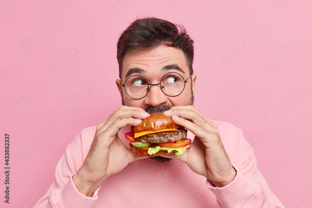 Gluttony And Overeating Concept Handsome Bearded Man Bites Delicious