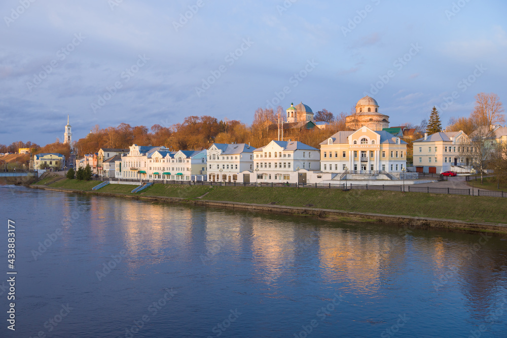 View of the city embankment on a April evening. Torzhok, Tver region. Russia