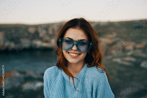 cheerful pretty woman in blue glasses outdoors travel luxury