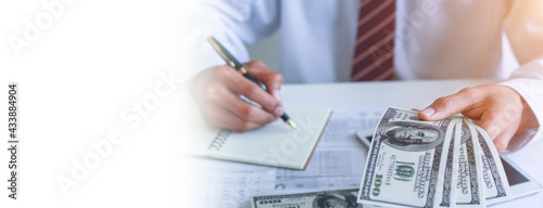 Obraz na plátně Businessman with money in hand, US dollar,investment, success and profitable business concepts