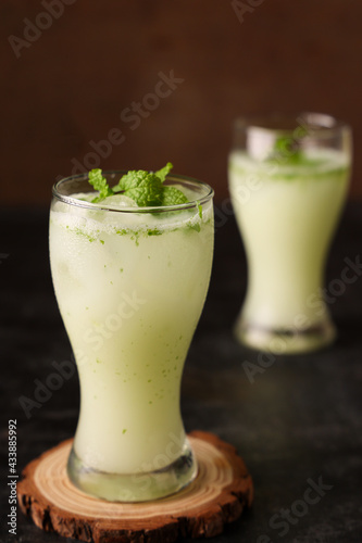 Spiced buttermilk , chaas , chaach , moru , sambharam , curd, lassi , yogurt, cool refreshing drink for hot summer in glass, Kerala, India Sri Lanka. Flavored Indian buttermilk. photo