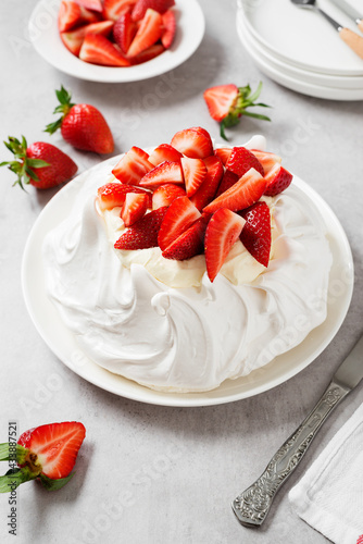 Homemade delicious meringue cake "Pavlova" with fresh strawberry and whipped mascarpone cheese cream . 