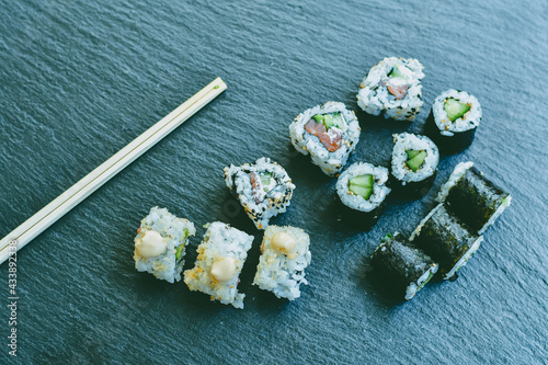 Japanese sushi food. Maki ands rolls with tuna, salmon, shrimp.Assorted sushi. Rainbow roll, uramaki, hosomaki and nigiri. Sushi Set sashimi served on stone slate