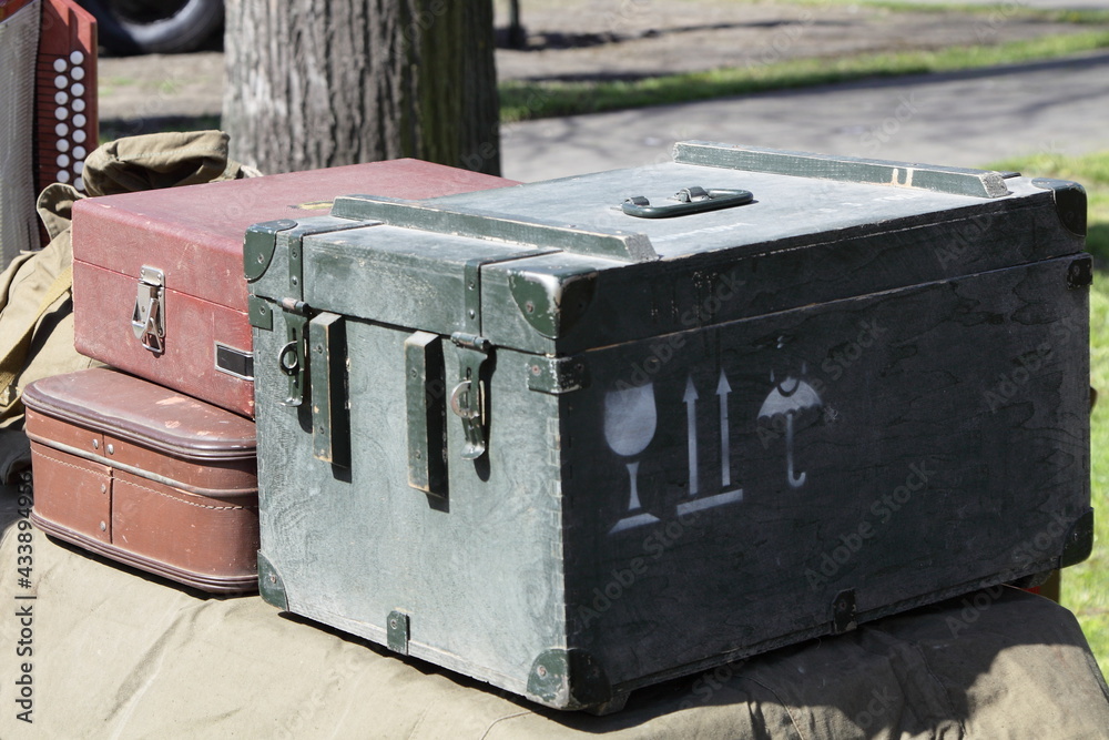 An old wooden ammunition box abd a brown vintage suitcases - Soviet WWII wartime equipment An old wooden ammunition box abd a brown vintage suitcases - Soviet WWII wartime equipment