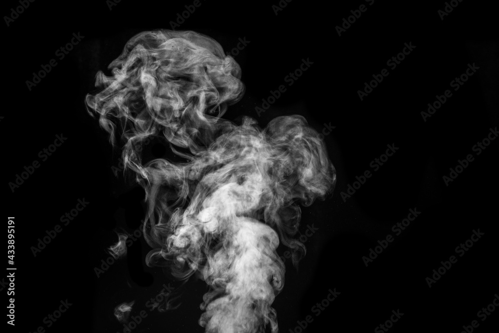 Figured smoke on a dark background. Abstract background, design element, for overlay on pictures. Figured smoke on a dark background. Abstract background, design element, for overlay on pictures.