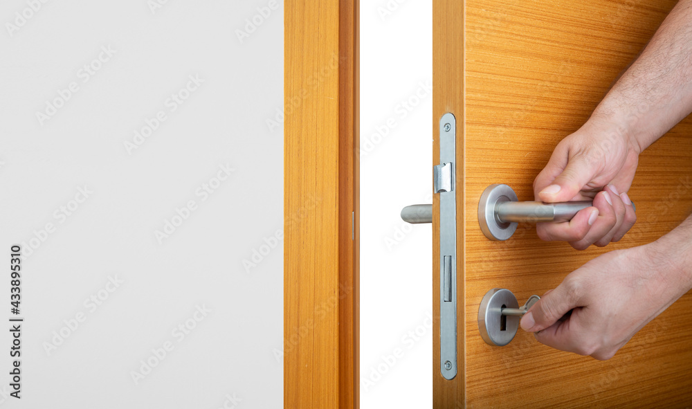 Obraz premium hand holding door handle. Front view