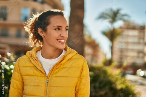 Young hispanic girl smiling happy standing at the park