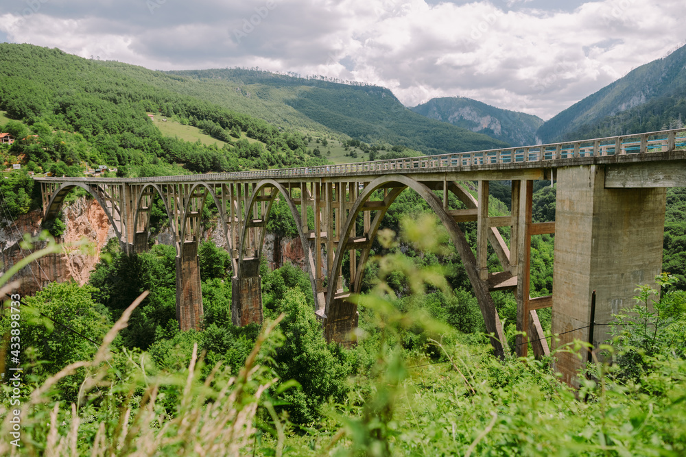 Beautiful bridge over a river in mountains of Montenegro. Tara Bridge. Canyon in mountains.