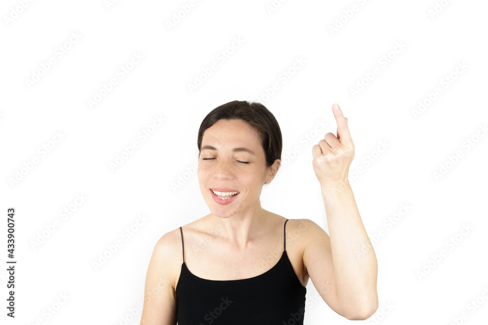 Young beautiful woman pointing up with fingers while thinking at white empty background Young beautiful woman pointing up with fingers while thinking at white empty background