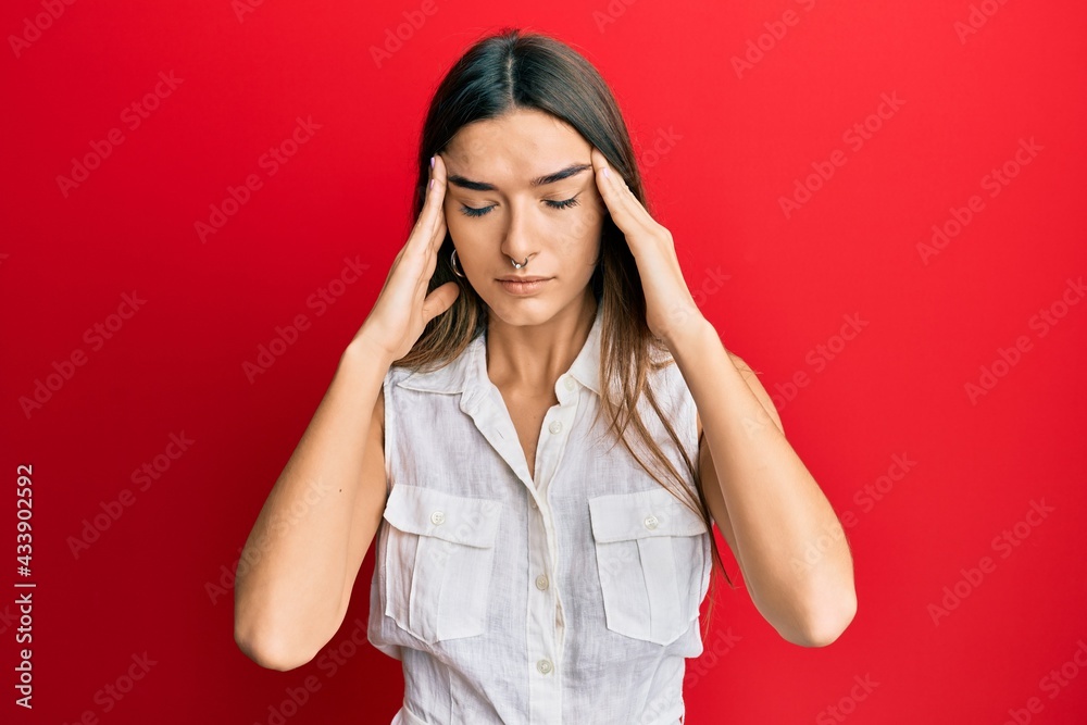 Young hispanic woman wearing casual clothes with hand on head, headache because stress. suffering migraine. Young hispanic woman wearing casual clothes with hand on head, headache because stress. suffering migraine.