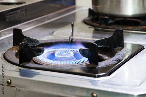 Burning blue flame gas on kitchen stove. Safety issue concept.