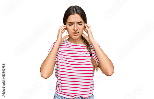 Young hispanic woman wearing casual clothes covering ears with fingers with annoyed expression for the noise of loud music. deaf concept.