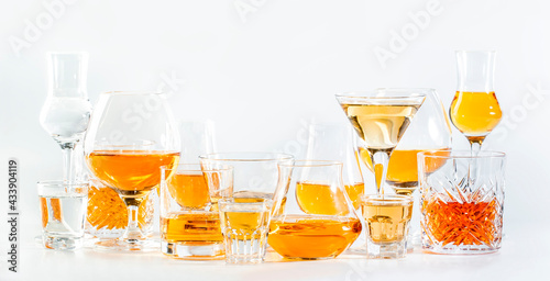 фотографія Hard strong alcoholic drinks, spirits and distillates in glasses in assortment: vodka, cognac, scotch, whiskey etc