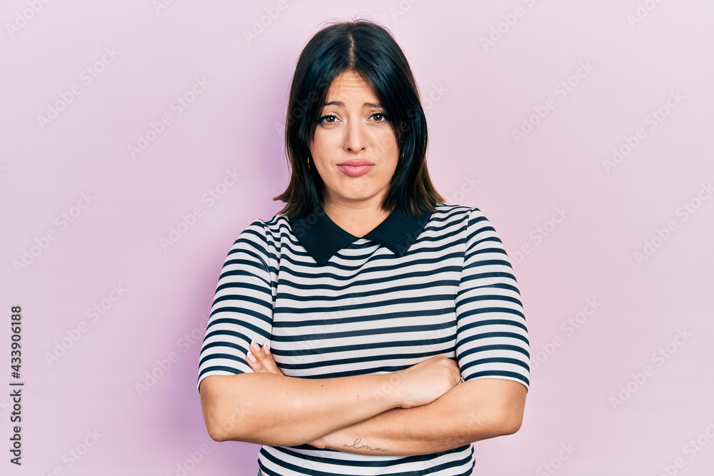 Fototapeta premium Young hispanic woman with arms crossed gesture skeptic and nervous, frowning upset because of problem. negative person.
