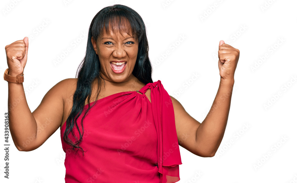 Hispanic middle age woman wearing casual clothes screaming proud, celebrating victory and success very excited with raised arms Hispanic middle age woman wearing casual clothes screaming proud, celebrating victory and success very excited with raised arms