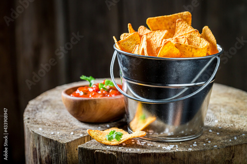 Mexican snack popular in the cinema. Nachos in metal bucket.