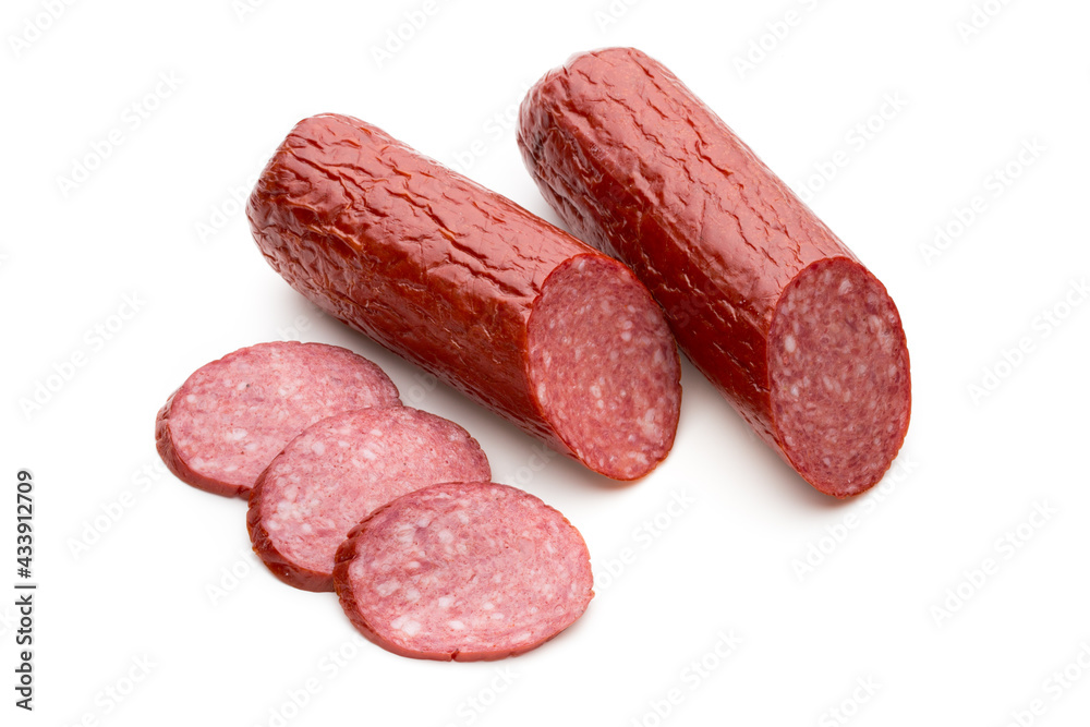 Salami smoked sausage, basil leaves on white background cutout. Salami smoked sausage, basil leaves on white background cutout.
