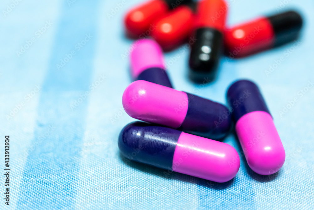 Pharmaceutical medicine pills in both tablets and capsules with the vintage retro picture style. Pharmacy theme and treatment medication as concept. Pharmaceutical medicine pills in both tablets and capsules with the vintage retro picture style. Pharmacy theme and treatment medication as concept.