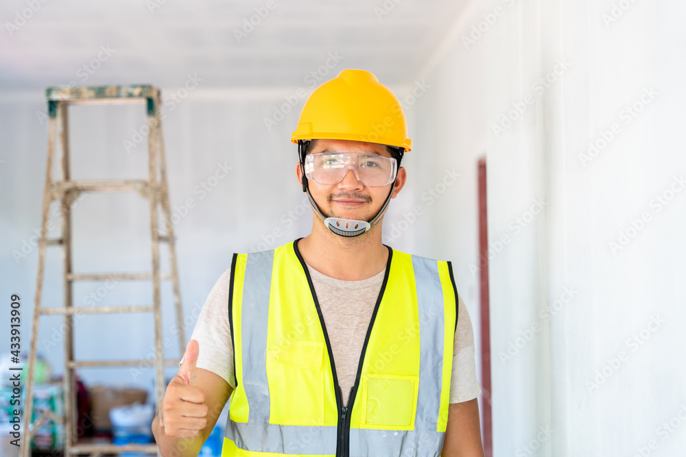 Happy asian engineer or architecture and construction business concept - businessman or architect in helmet at the construction site, building Happy asian engineer or architecture and construction business concept - businessman or architect in helmet at the construction site, building