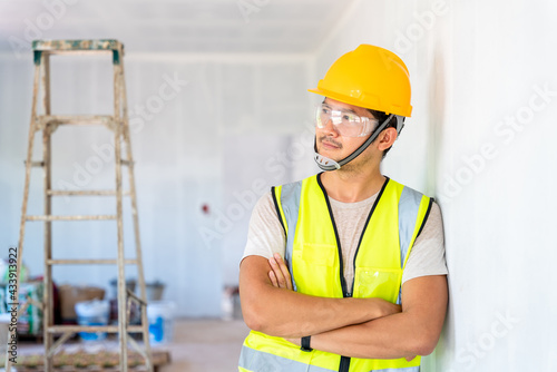 Asian engineer or architecture and construction business concept - businessman or architect in helmet at the construction site, building