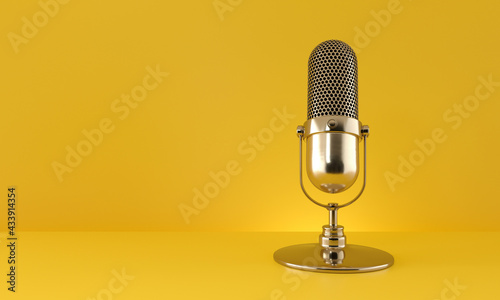Gold microphone on yellow background.