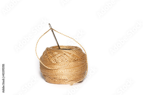 Darning Needle and ball of thread isolated on a white Background. Home repair and sewing kit.