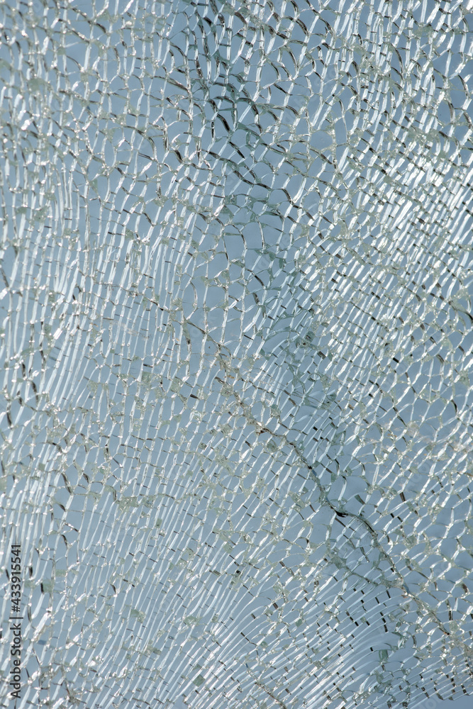Fototapeta premium Shattered, cracked glass backlighting, destoryed wildscreen