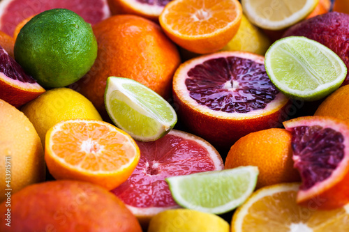 Close up of fresh juicy citrus fruits - oranges  mandarins  lemons and limes  top view