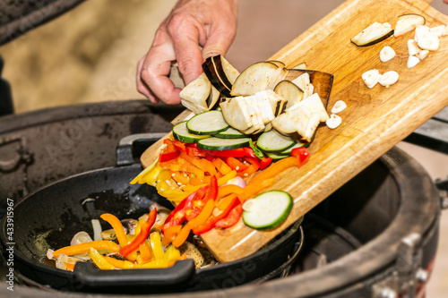 Chef prepares fresh vegetables on the grill. Close up