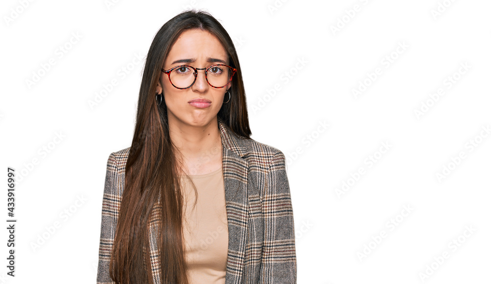Young hispanic girl wearing business clothes and glasses depressed and worry for distress, crying angry and afraid. sad expression.