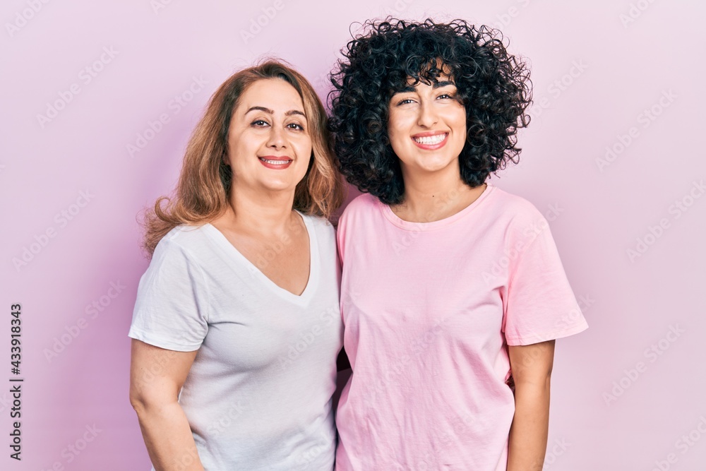 Middle east mother and daughter wearing casual clothes with a happy and cool smile on face. lucky person. Middle east mother and daughter wearing casual clothes with a happy and cool smile on face. lucky person.