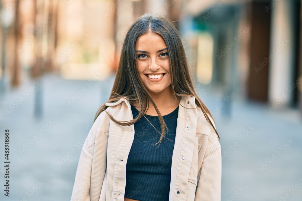 Young hispanic girl smiling happy standing at the city. Young hispanic girl smiling happy standing at the city.