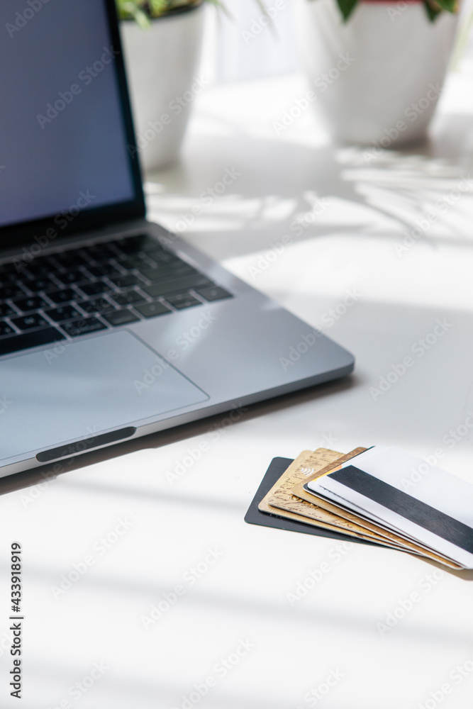 few credit deposit cards on the table near laptop few credit deposit cards on the table near laptop