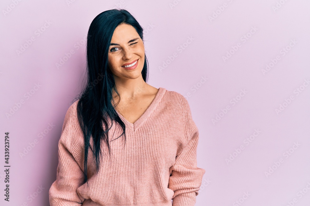 Fototapeta premium Young caucasian woman wearing casual clothes winking looking at the camera with sexy expression, cheerful and happy face.