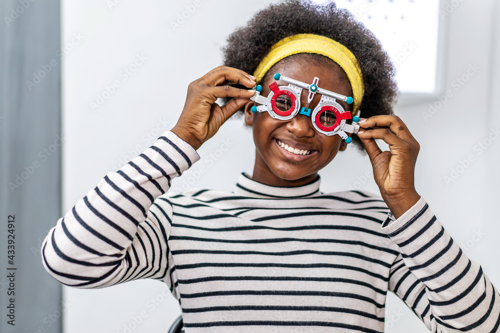 Smiling young woman african american checking vision with eye test glasses  during a medical examination at the ophthalmological office, Checking eye  vision by optician health examination concept Stock Photo | Adobe Stock