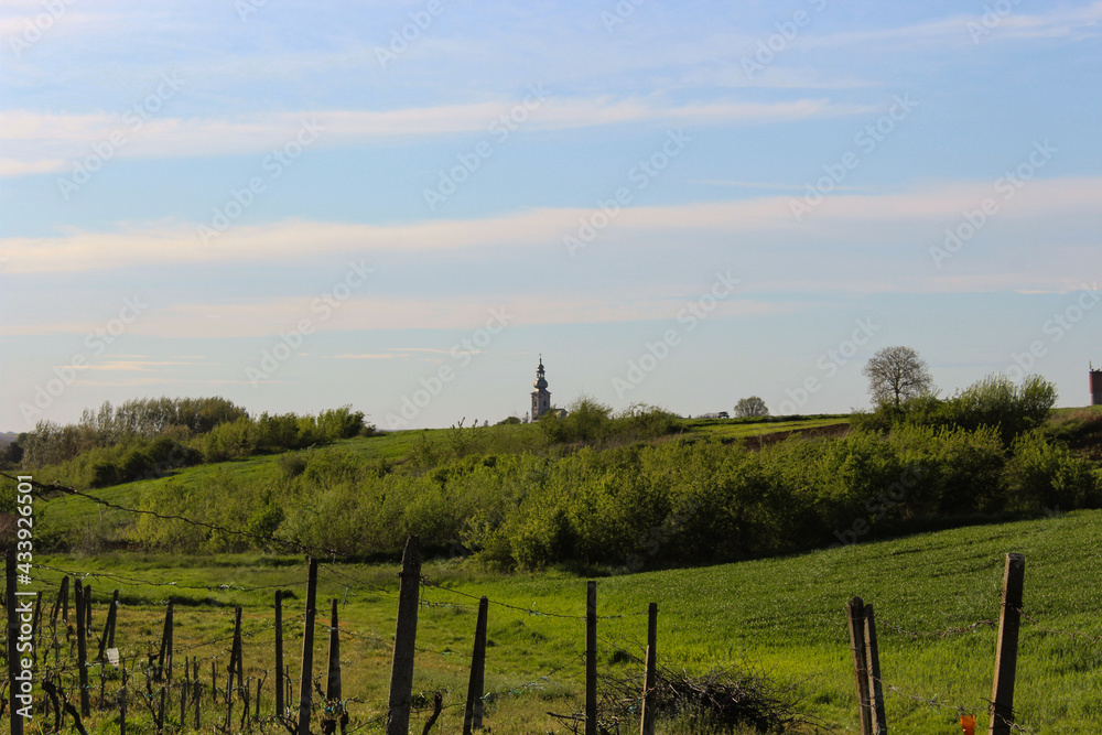 Fototapeta premium church behind a hill