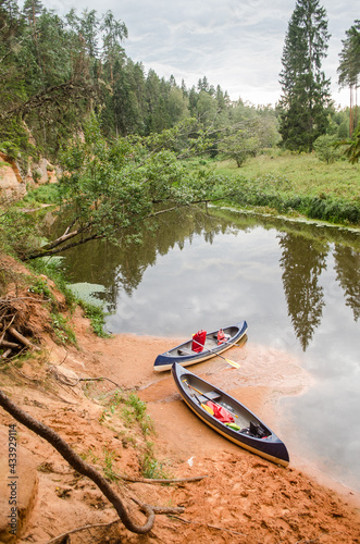 Boat trip down the river Salaca. Beautiful sand stone cliffs, Latvia.  photo