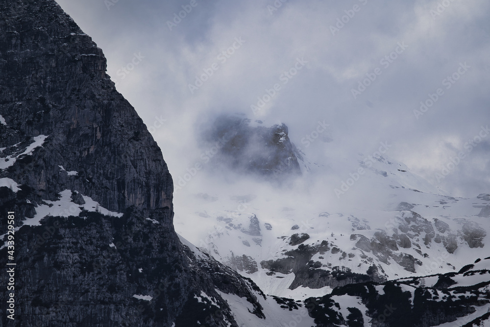 Dark mood -  dramatic clouds and fogs over the mountains and parts with snow