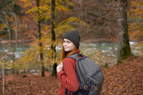 Autumn forest nature landscape tall trees and woman hiker with backpack © SHOTPRIME STUDIO