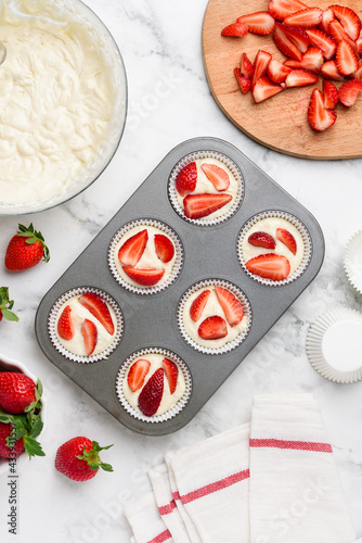 Homemade strawberry muffins in a baking dish. Cooking process. Strawberry cupcakes. Culinary concept.  Top view.