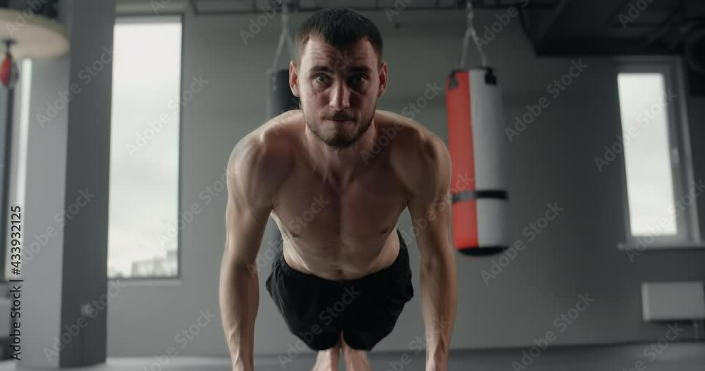 Athlete performs fast push-ups on his fists at the gym, camera follows the movement, workout training, 4k 60p Prores HQ Athlete performs fast push-ups on his fists at the gym, camera follows the movement, workout training, 4k 60p Prores HQ