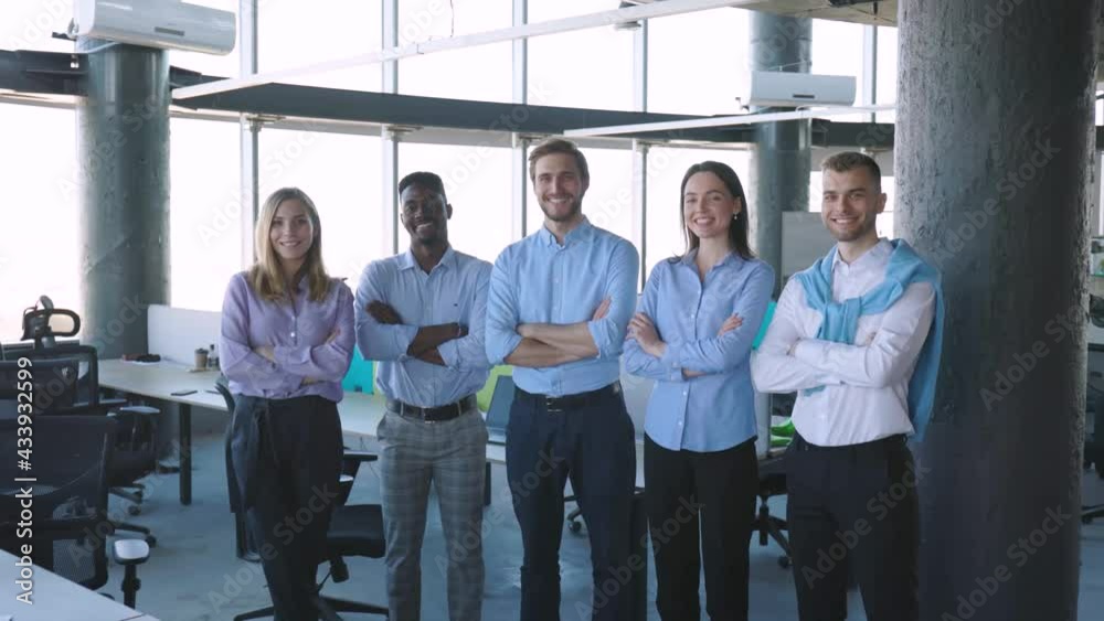 Group of businesspeople standing together in office. Group of businesspeople standing together in office.